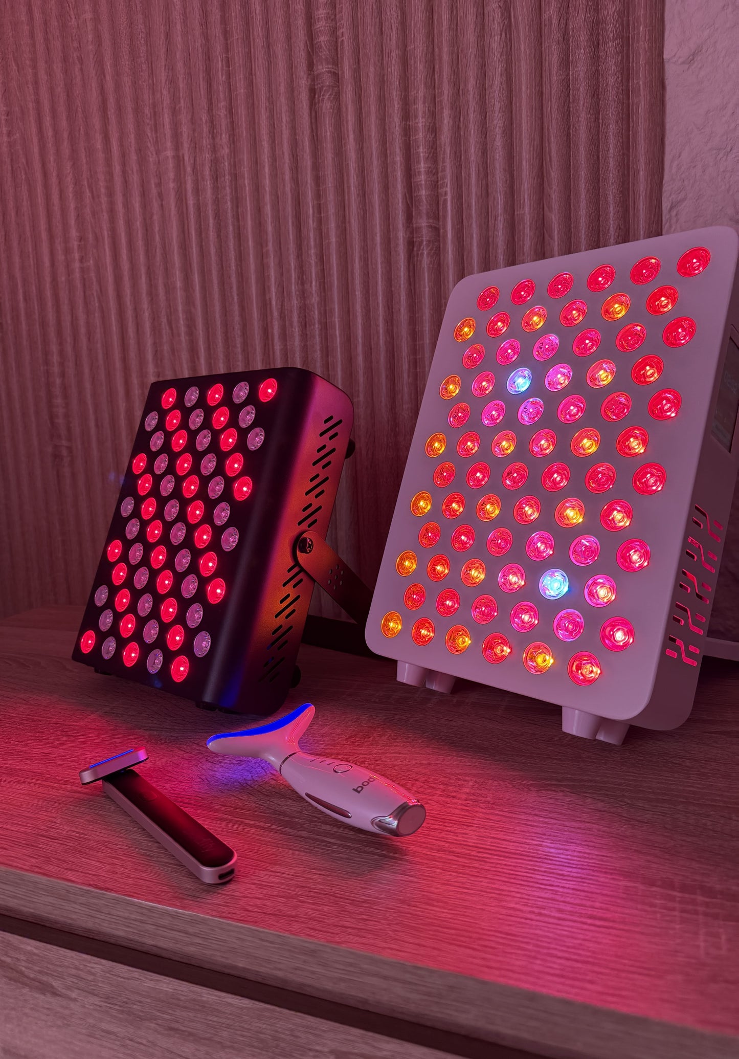 Close-up of Bodify red light therapy devices and skincare tools arranged together