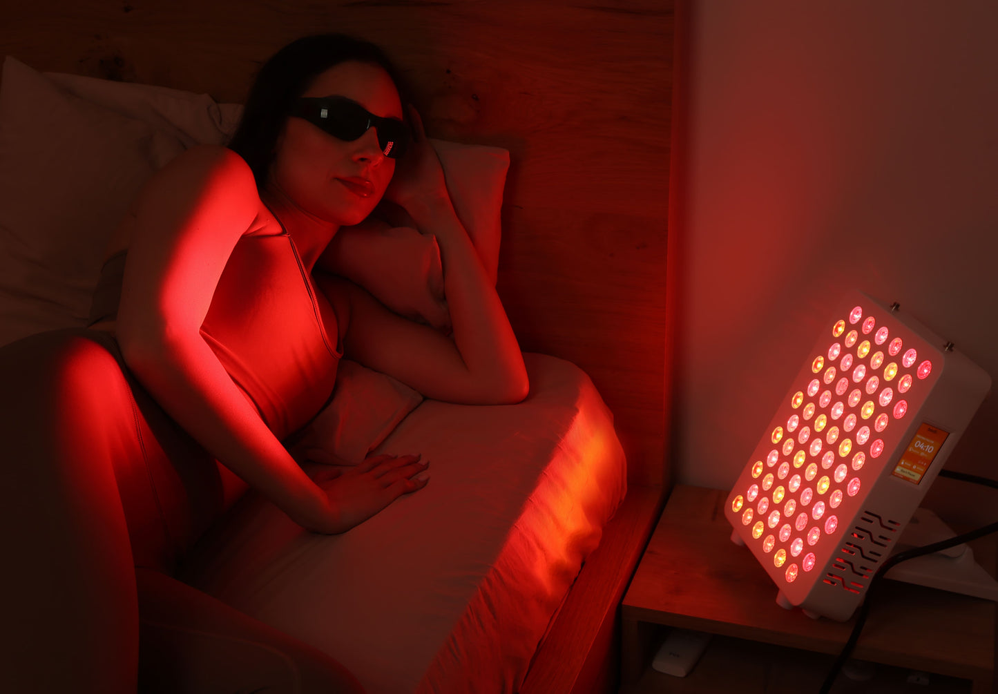 bedside-session.jpg
Woman relaxing in bed beside a red light therapy panel during a home session