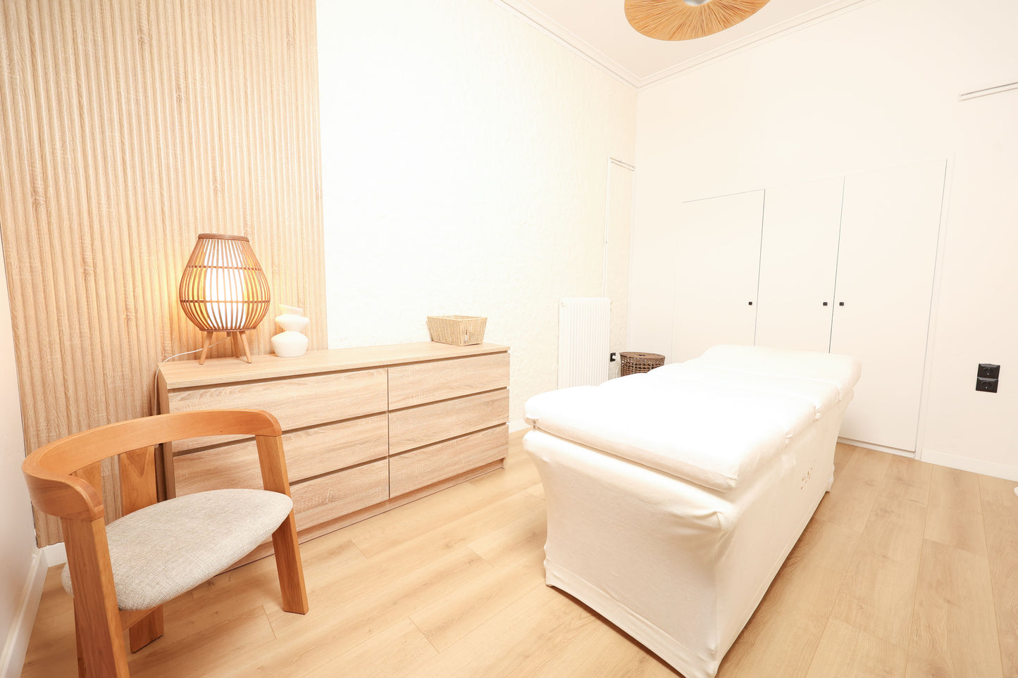Bodify treatment room with massage bed and warm minimalist decor