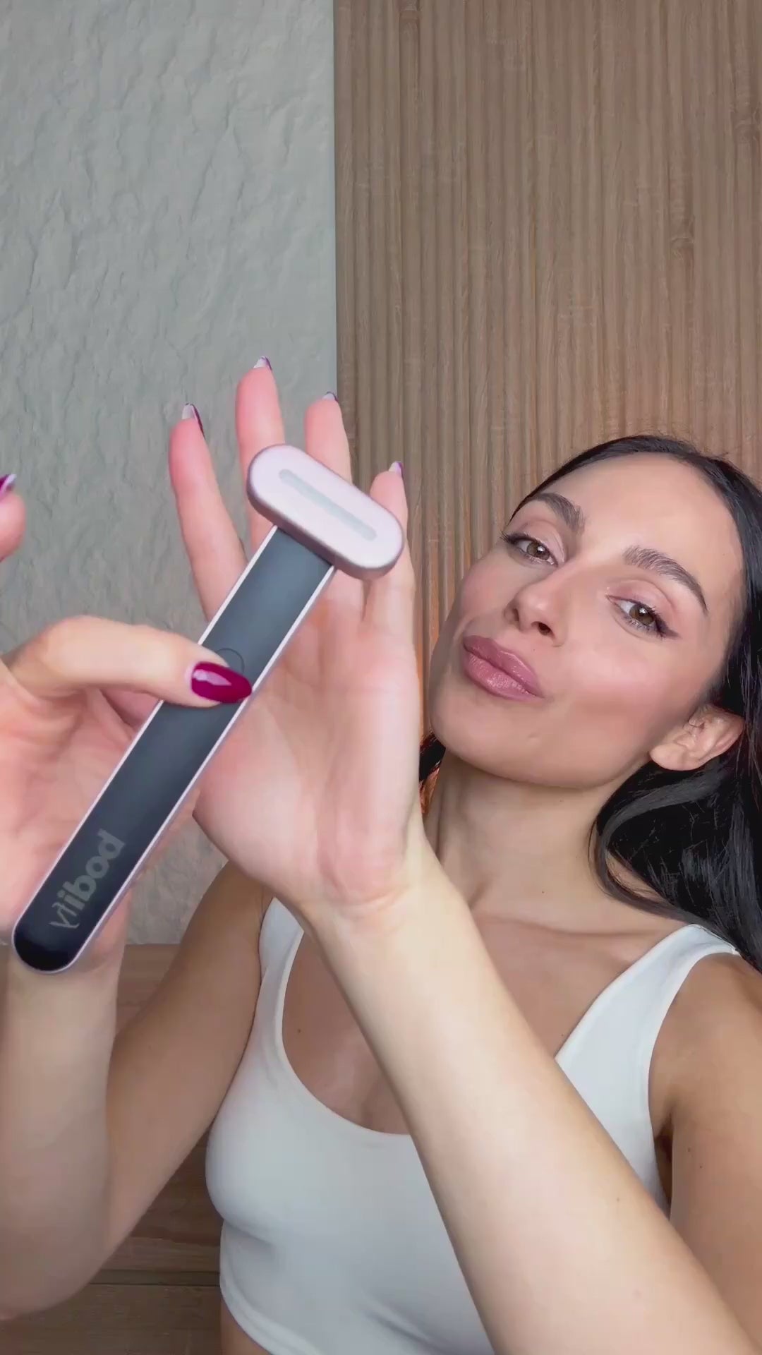 Woman using the Bodify Red Light Massager in a wellness lifestyle video