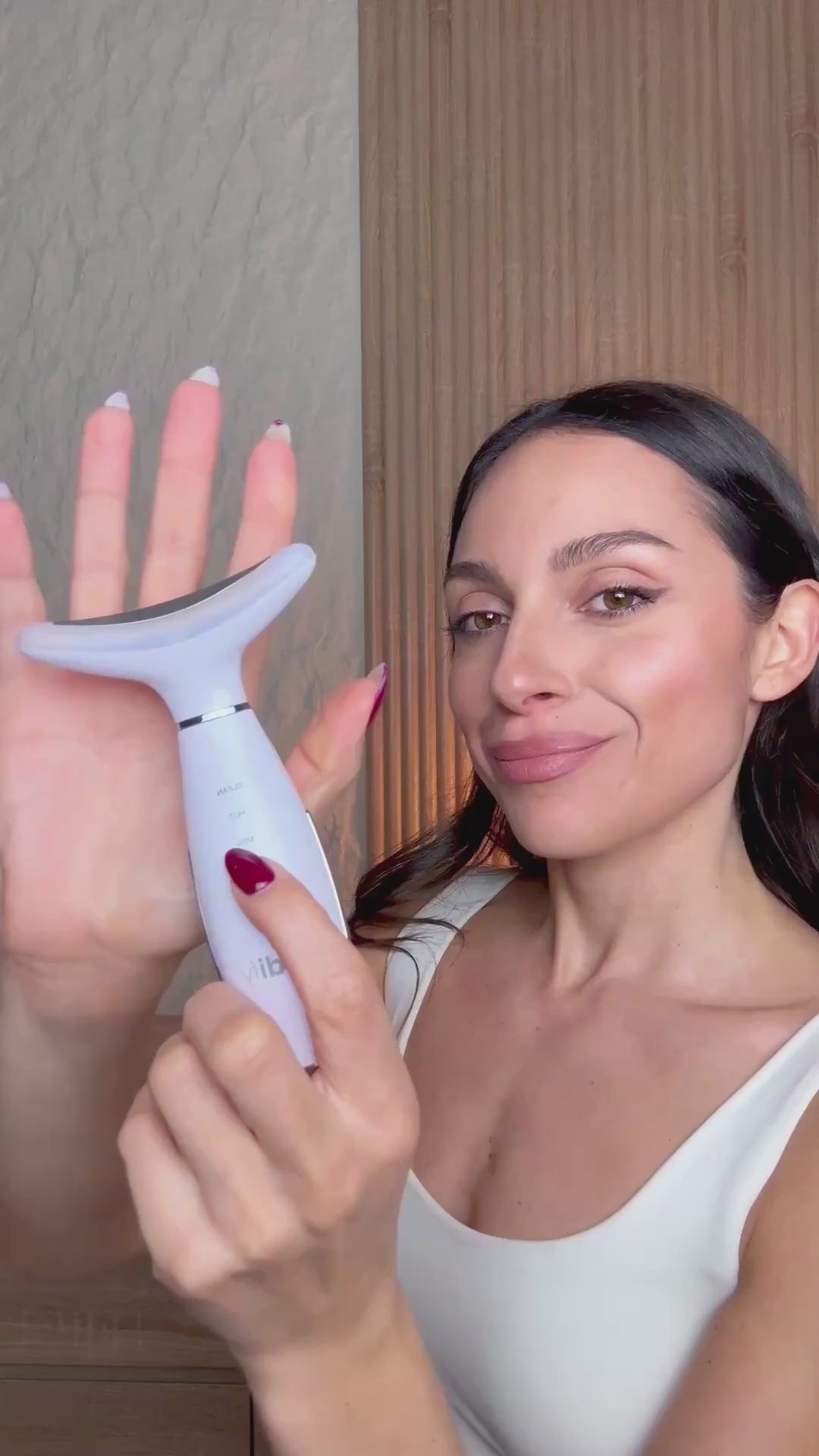 Woman using the Bodify Red Light Massager on the neck and jawline